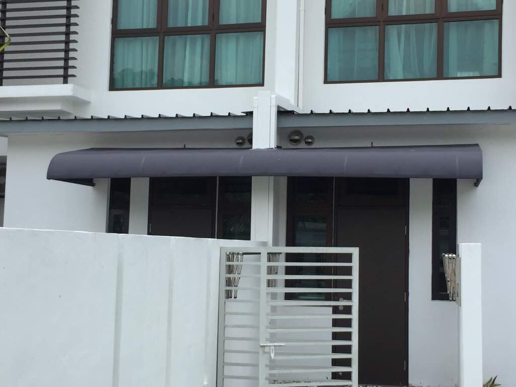 Permanent steel-framed fixed canopy over the entrance of a modern Malaysian home