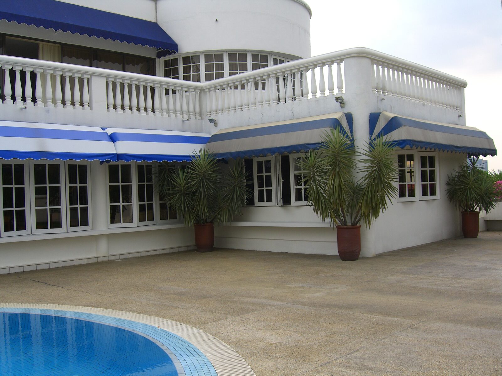 Fixed canopy shading a poolside terrace at a Malaysian home