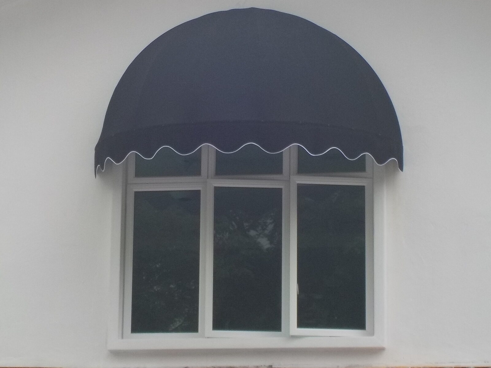 Navy domed canopy over a feature window on a modern Malaysian home